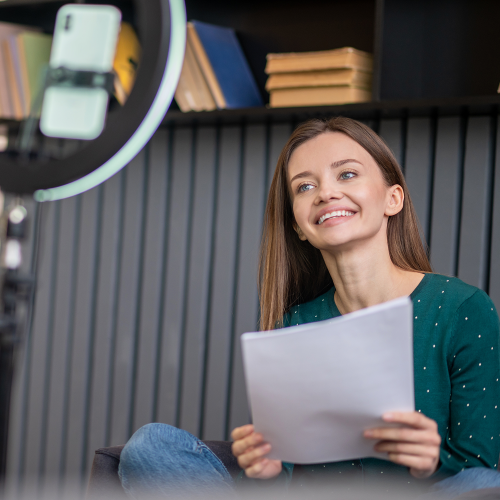 cute-smiling-young-woman-with-paper-hands 1